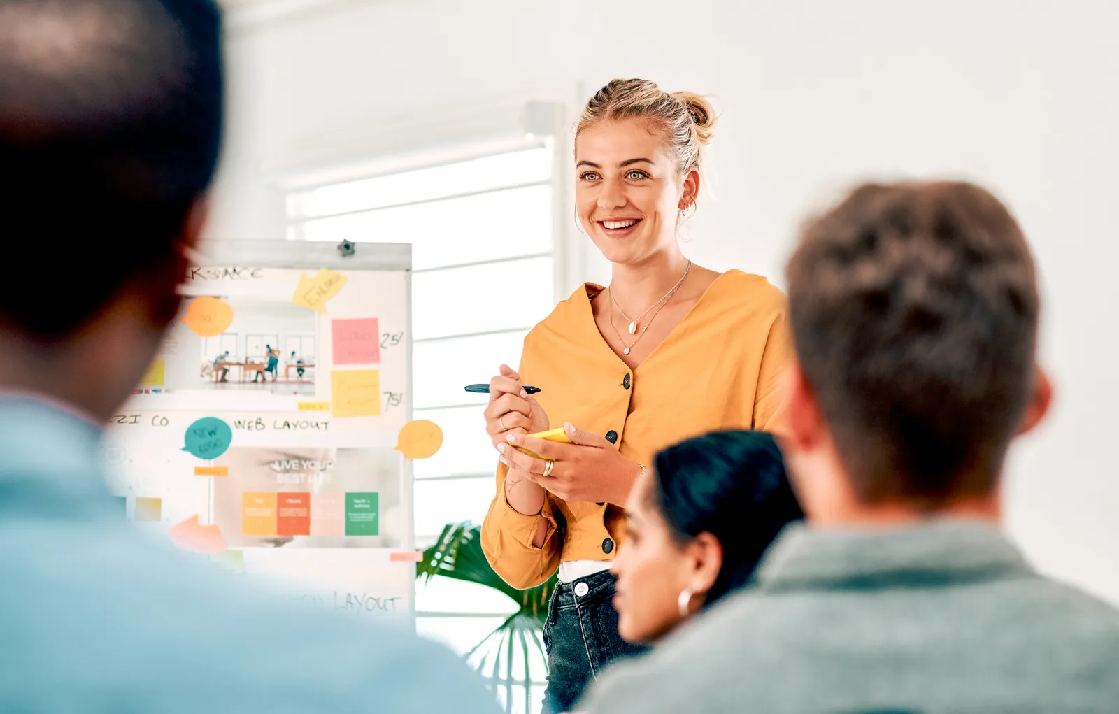 A business owner presenting ideas in a bright workspace.