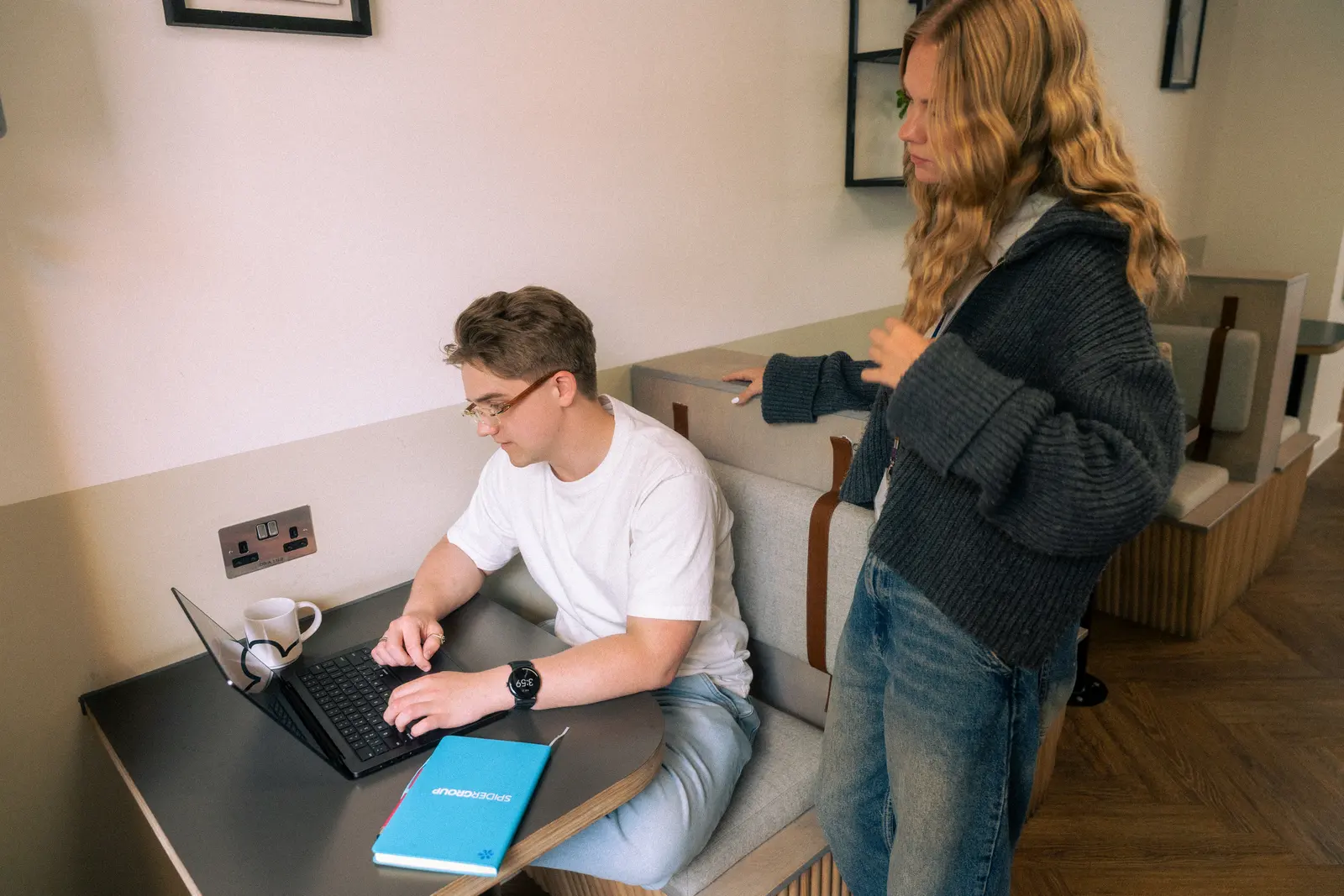 Exposure Marketing team collaborating at a desk with a laptop.