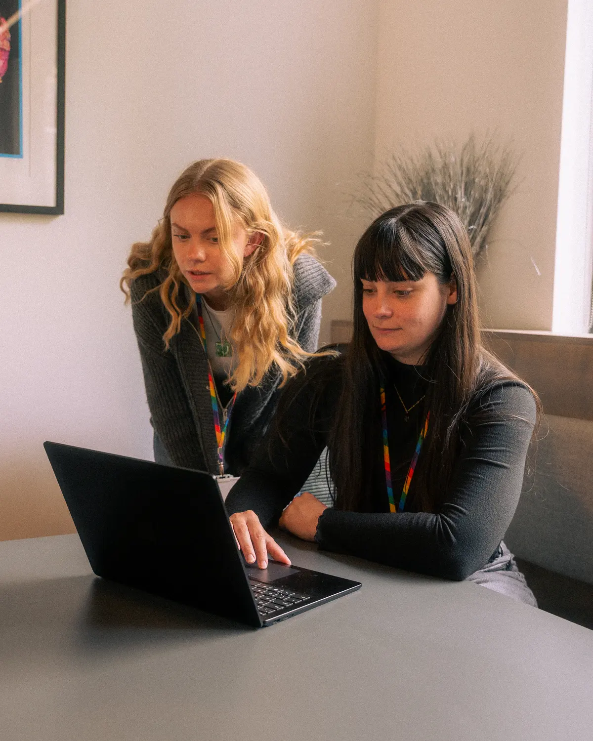 Exposure Marketing team reviewing work together in a booth.