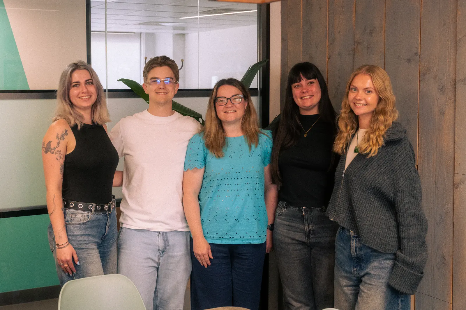 Exposure Marketing team standing together in the office.