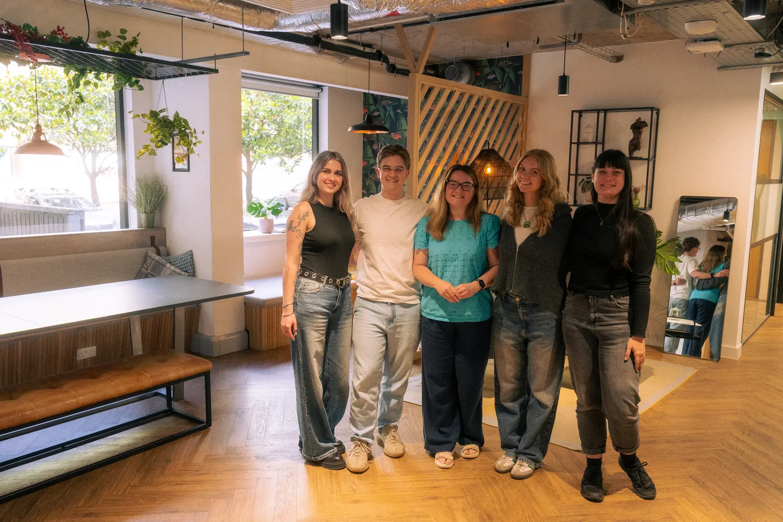 Exposure Marketing team standing together in the office lounge.