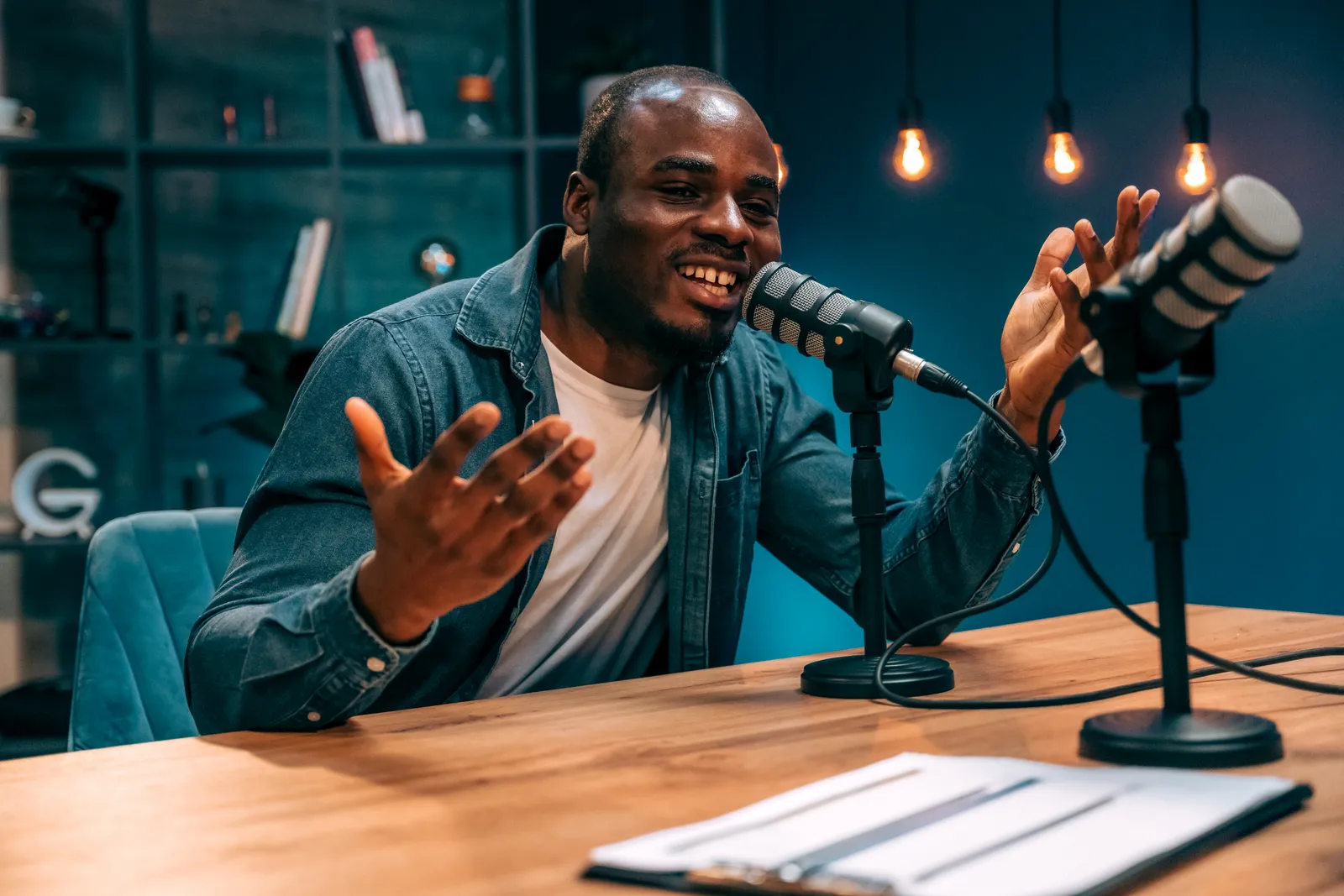 A podcast host recording content in a studio.