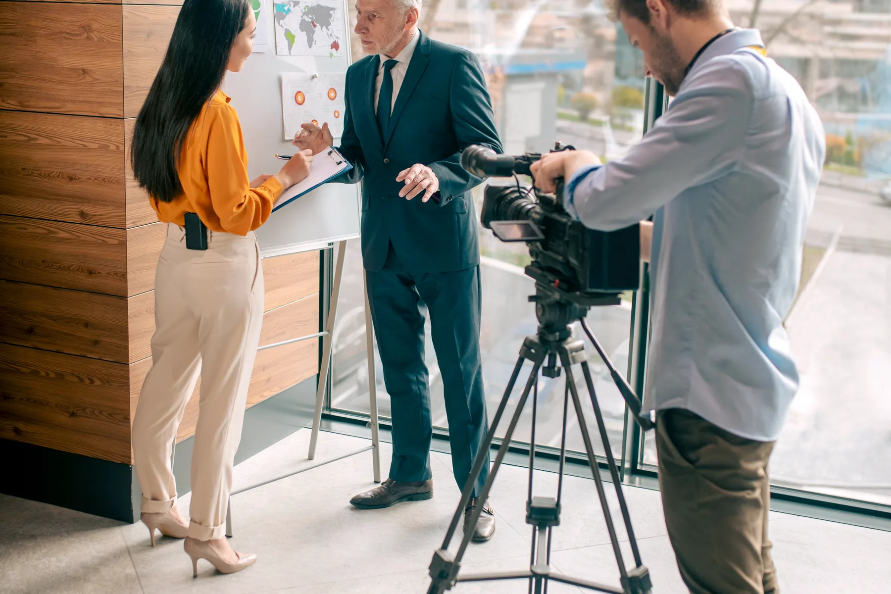 Journalists and guest working in a studio.