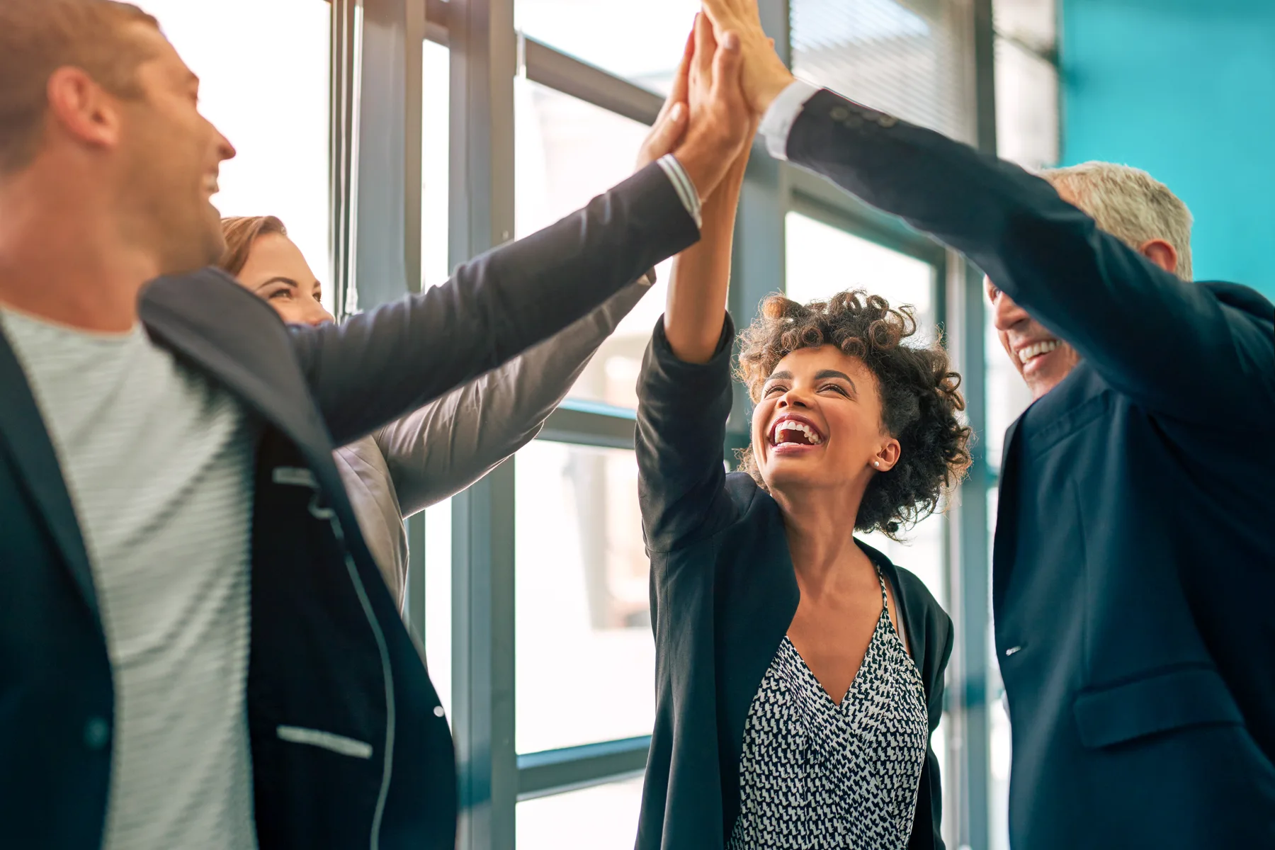Team high-fiving after successful work.