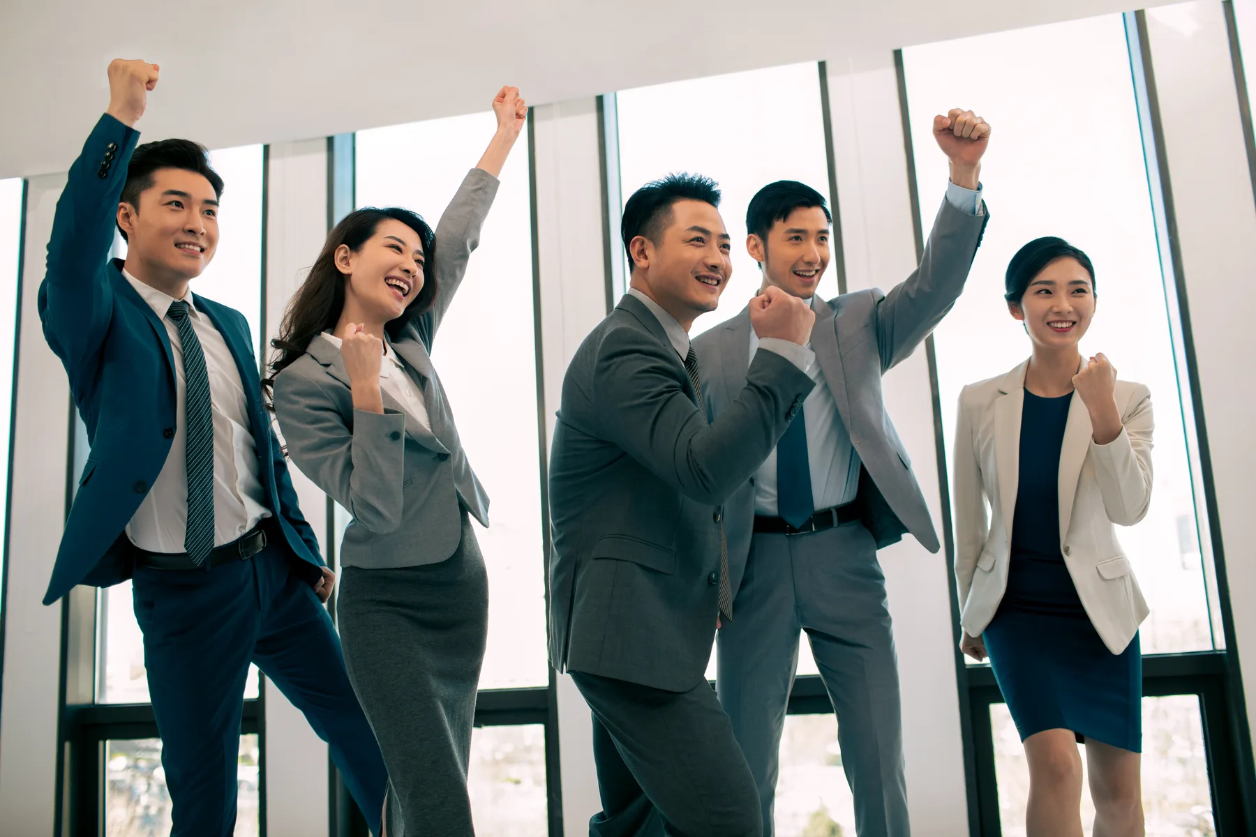 Professionals celebrating in an office building.